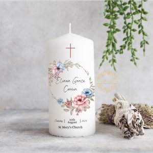 Personalized Christening candle with soft blue and pink floral design, featuring custom name, date, and church details, perfect for baby girl or boy's baptism ceremony.